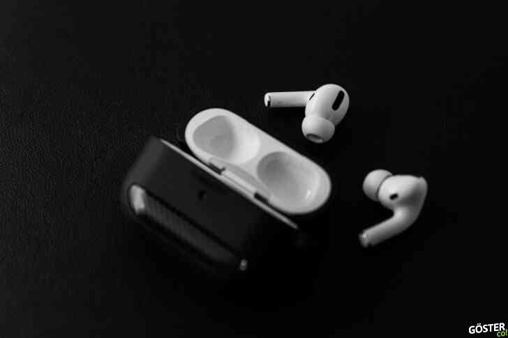 white apple earpods beside black leather case