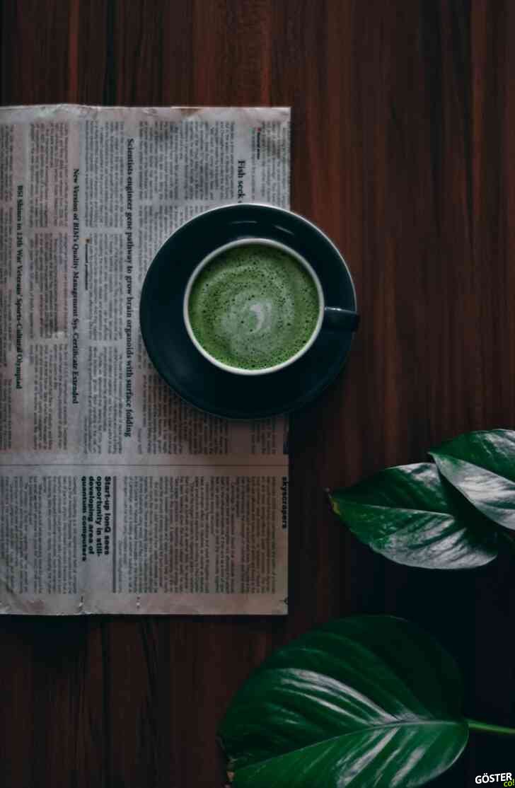 green ceramic round plate on brown wooden table