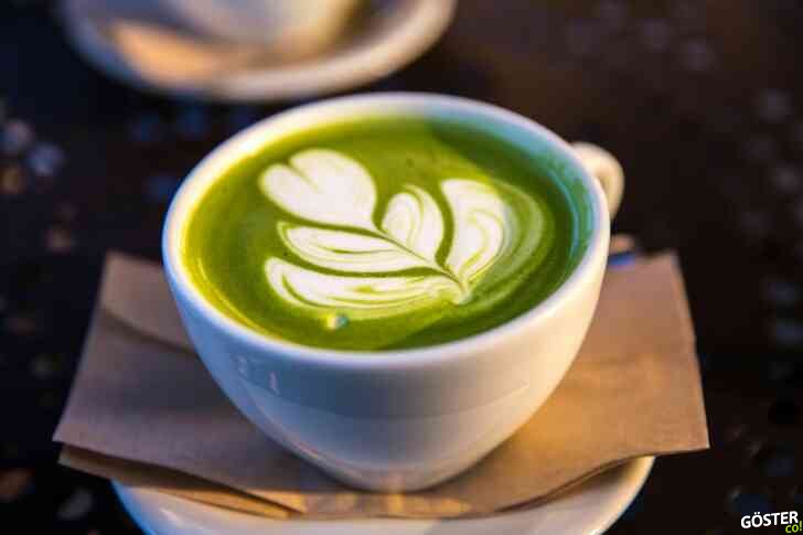 white ceramic teacup filled of matcha tea